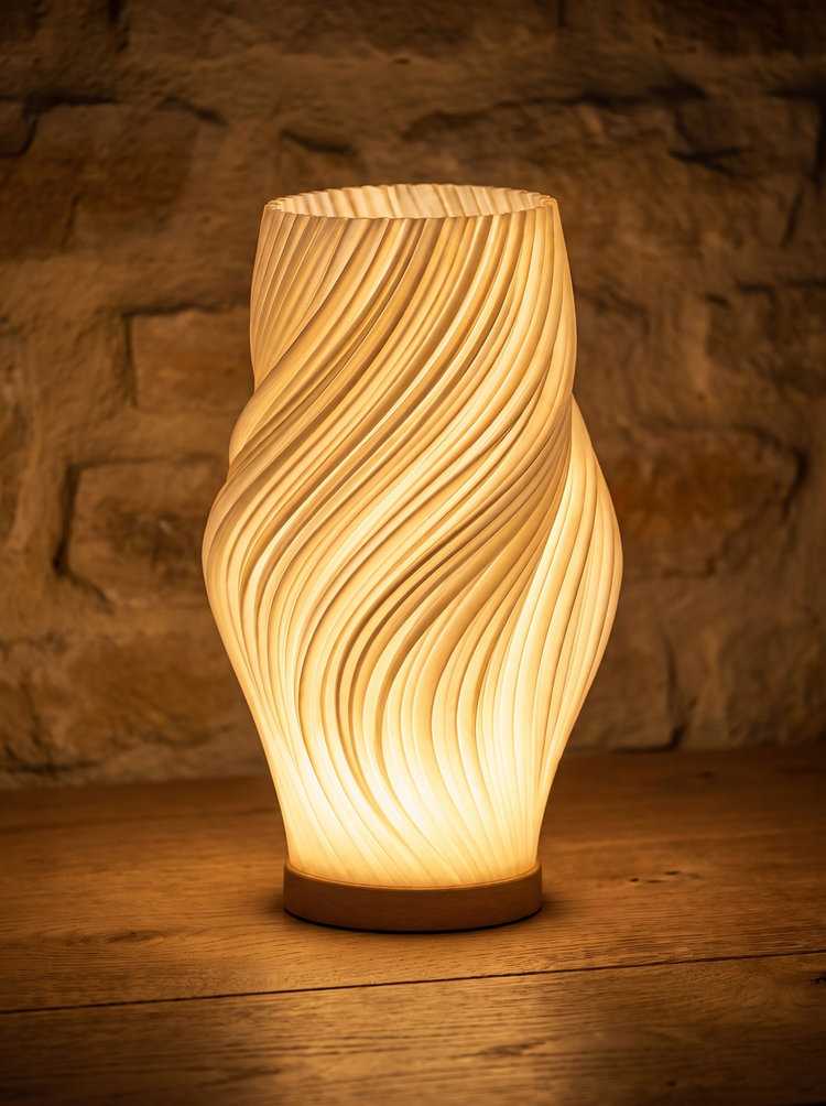 Onda lamp spiral shade against a stone wall